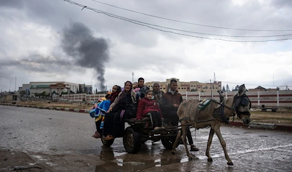 Palestinians flee from the city of Khan Younis in southern Gaza after an Israeli ground and air offensive on Monday, Jan. 29, 2024 (AP Photo/Fatima Shbair)