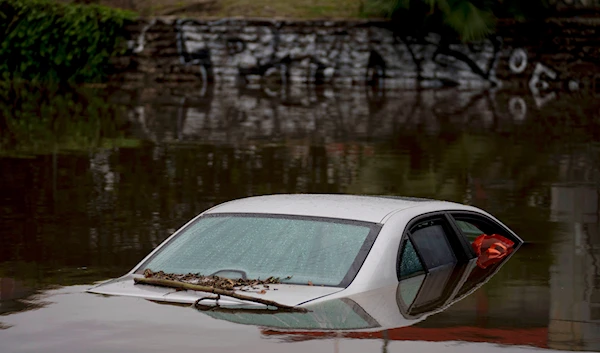 A car sits submerged on a flooded street under a railroad bridge, Thursday, Feb. 1, 2024 in Long Beach, California(AP)