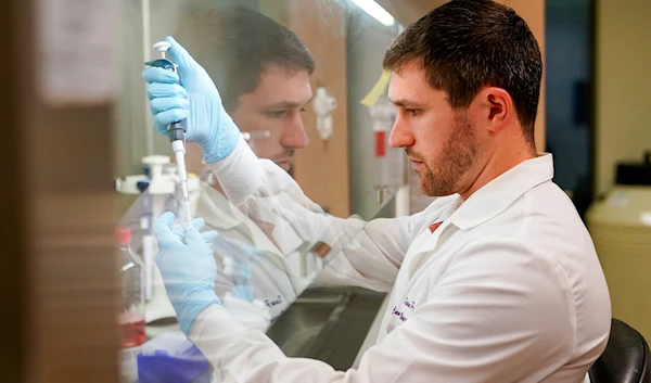 Research scientist Kevin Potts uses ovarian cancer cells to set up an experiment at UW Medicine's Cancer Vaccine Institute Thursday, May 25, 2023, in Seattle.(AP)