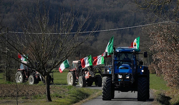 Manuele Calzoni, center, drives his tractor to join the protest of other farmers near the highway junction, in Orte, Italy, Saturday, Feb. 3, 2024(AP)