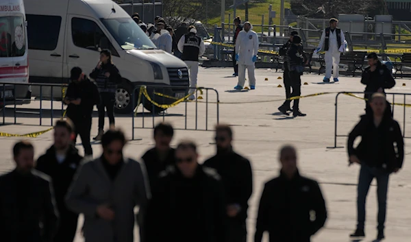 Security officers check the site where two attackers were killed outside a courthouse in Istanbul, Turkey, Tuesday, Feb. 6, 2024. (AP)