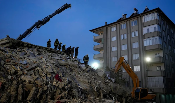 Firefighters search for people in the rubble of a destroyed building, in Gaziantep, southeastern Turkey, Wednesday, Feb. 8, 2023. (AP)