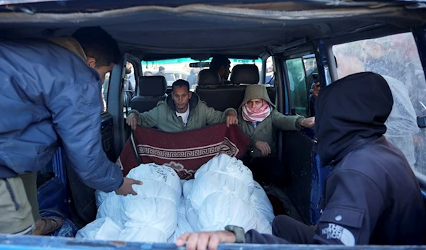 Palestinians transport their relatives killed in the Israeli bombardment of the Gaza Strip in Deir al Balah, occupied Palestine, Monday, Feb. 5, 2024. (AP)