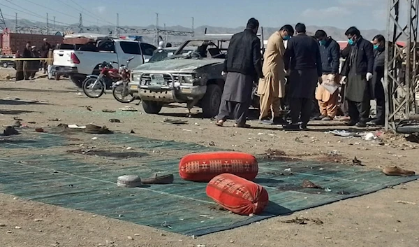 Security officials examine the scene of a bomb blast in Khanozai, Pashin, a district of Pakistan's Baluchistan province, Wednesday, Feb. 7, 2024. (AP)