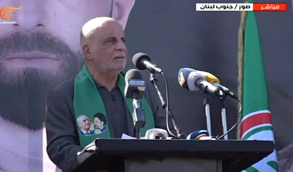 Member of the Lebanese Parliament, Ali Khreis, delivers his speech at the funeral of the martyrs of the Amal Movement on the Jerusalem Road in the city of Tyre, southern Lebanon. (ScreenGrab/Al Mayadeen Broadcast)