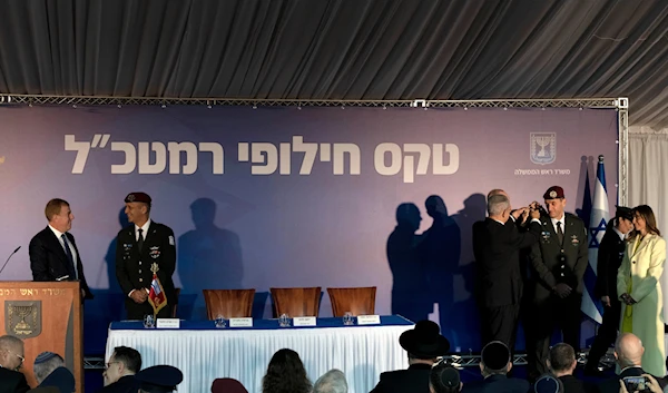 Sharon Halevi watches as Benjamin Netanyahu, promotes her husband, the new IOF Chief to the rank of Lieutenant-General as outgoing chief Aviv Kochavi, chats on the stage in occupied al-Quds, Monday, Jan. 16, 2023(AP)