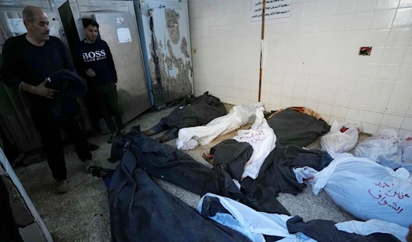 Palestinians look at the bodies of relatives killed in the Israeli bombardment of the Gaza Strip, inside a morgue of Al Aqsa hospital, in Deir al Balah, Gaza Strip, Tuesday, Feb. 6, 2024 (AP Photo/Adel Hana)