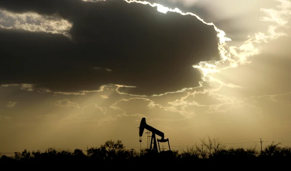 A pump jack is seen operating as clouds cover a setting sun in Lubbock, Texas, Wednesday, Nov. 11, 2006 (AP Photo/Tony Gutierrez)