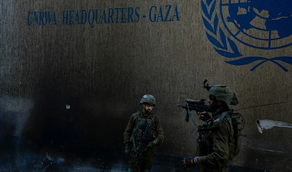 Israeli occupation forces take up positions as they raid the UNRWA headquarters in the Gaza Strip, on Thursday, February 8, 2024. (AP)