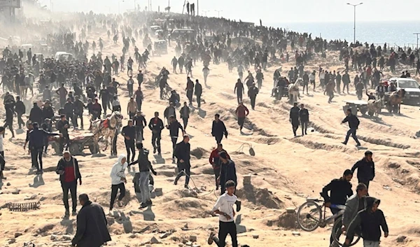 Palestinians wait for humanitarian aid on a beachfront in Gaza City, Gaza Strip, Palestine, Sunday, Feb. 25, 2024. (AP)