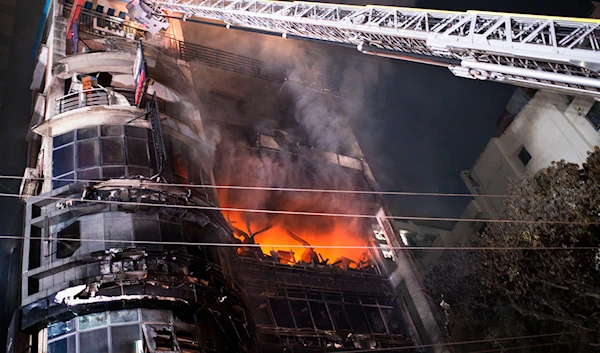 Firefighters work to contain a fire that broke out at a commercial complex in Dhaka, Bangladesh, Thursday, Feb. 29, 2024. (AP)