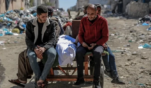 The body of a Palestinian killed when IOF opened fire on people waiting for aid in Gaza City on February 29, 2024 (AFP)