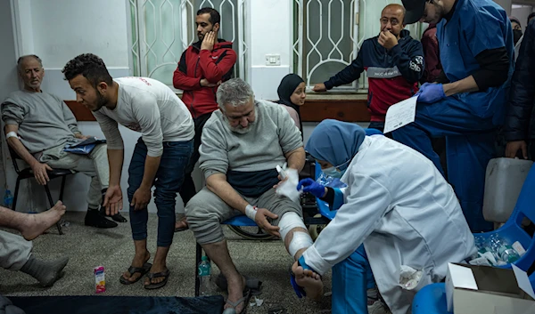 Palestinians who were detained by the Israeli occupation forces in the north of the Gaza Strip and released through the "Kerem Shalom" crossing in the south are treated in Rafah on Sunday, Dec. 24, 2023. (AP)