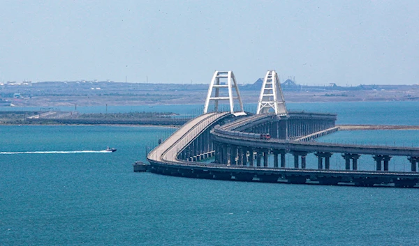 A freight train runs on rails of a railway link of the Crimean Bridge connecting the Russian mainland and the Crimean peninsula over the Kerch Strait not far from Kerch, Crimea, on Monday, July 17, 2023. (AP)