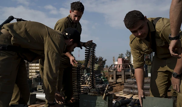 Israeli occupation forces troops store ammunition in a staging area in southern occupied Palestine, Tuesday, Jan. 2, 2024.(AP)