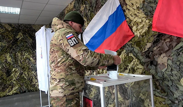 Image taken from a video released by the Russian Defense Ministry Press Service on Monday, March 11, 2024, a Russian serviceman votes in the Zaporizhzhia region, eastern Ukraine.(AP)