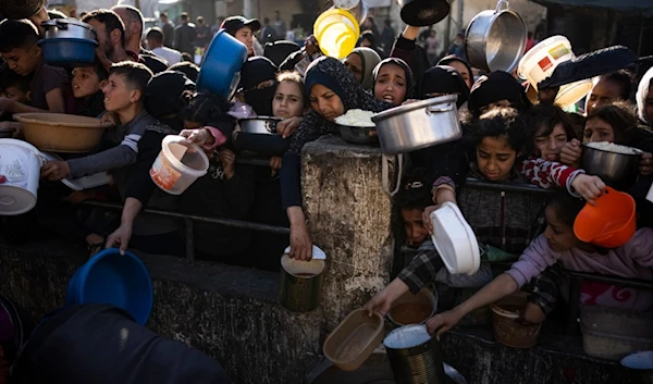 Palestinians line up for food in Rafah, Gaza Strip, on Tuesday, March 12, 2024. (AP)