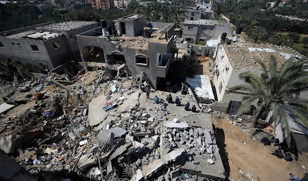 Palestinians look at destruction after an Israeli airstrike on a residential building of the Ganan family in Deir al-Balah, Gaza Strip, Thursday, March 7, 2024. (AP)