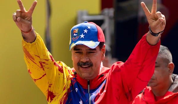 President Nicolas Maduro flashes victory signs during an event commemorating a 2004 speech by the late President Hugo Chavez, in Caracas, Venezuela, Feb 29, 2024.(AP)