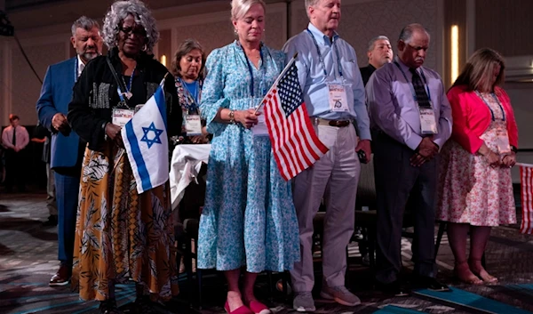 Holding US and Israeli flags, a crowd of largely Evangelical Christians pray during the Christians United For Israel (CUFI) 'Night to Honor Israel' during a summit, on July 17, 2023, in Va, US. (AP)