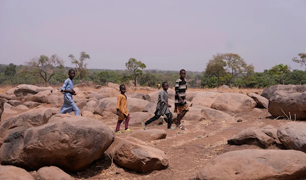 Children walk past the bush paths that the abducted schoolchildren of the LEA Primary and Secondary School followed in Kuriga, Kaduna Nigeria, Saturday March. 9, 2024. (AP)