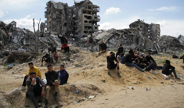 Palestinians children sit on the rubble of their Israeli-bombarded homes in Gaza City, Gaza Strip, occupied Palestine, March 9, 2024. (AP)