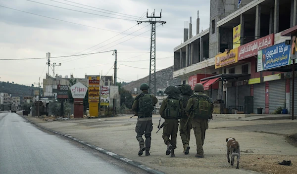 Israeli forces in the flashpoint Palestinian town of Hawara in the Occupied West Bank on Nov. 12, 2023 (AP)