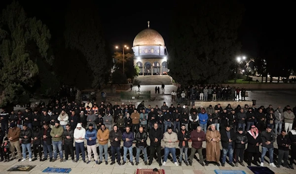 Muslim worshippers perform Taraweeh, an extra lengthy prayer held during the Muslim holy month of Ramadan at the Al-Aqsa Mosque compound in the Old City of al-Quds, Sunday, March 10, 2024. (AP)