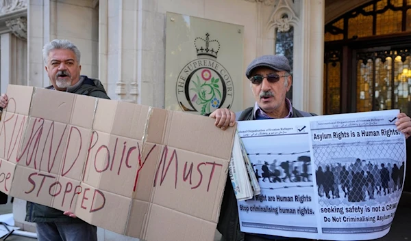 Protesters stand outside the Supreme Court in London, Wednesday, Nov. 15, 2023. (AP)