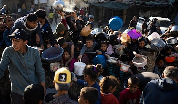 Palestinians line up for a free meal in Rafah, Gaza Strip, on Tuesday, March 12, 2024. (AP)