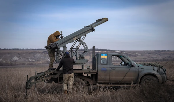 Ukrainian soldiers from The 56th Separate Motorized Infantry Mariupol Brigade prepare to fire a multiple-launch rocket system based on a pickup truck towards Russian positions at the front line, near Bakhmut, Donetsk, Russia, March 5, 2024 (AP)