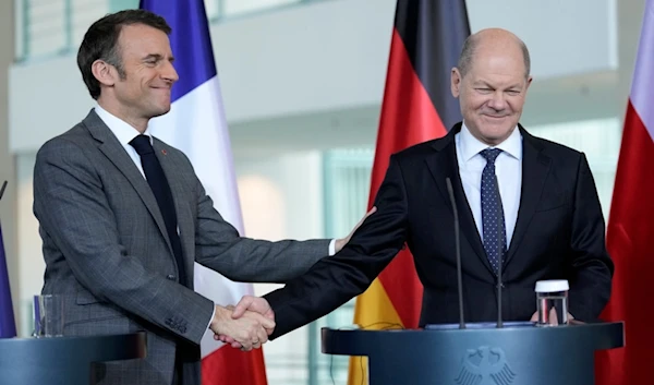 German Chancellor Olaf Scholz, right, and French President Emmanuel Macron reacts at a press conference in Berlin, Germany, Friday, March 15, 2024. (AP)