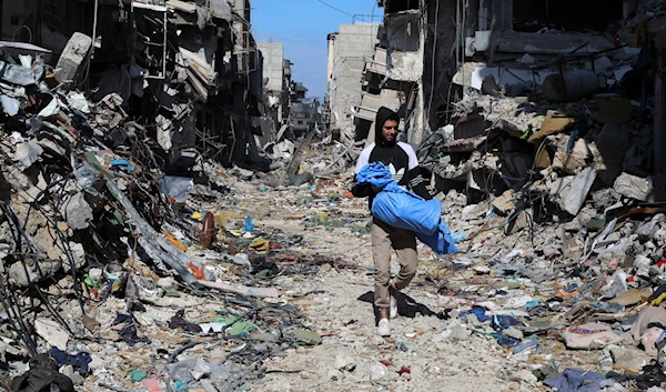 A Palestinian walks through the destruction left by the Israeli offensive on Khan Younis, Gaza Strip, Friday, March 8, 2024.(AP)