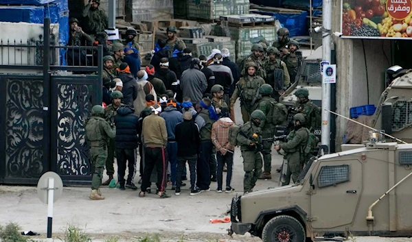 Israeli occupation forces detain Palestinian men during a raid in Nur Shams refugee camp in Tulkarm, West Bank on Wednesday, Jan. 3, 2024.(AP)