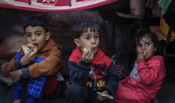 Palestinian children take shelter at a school run by the UNRWA in the city of Khan Younis in southern Gaza on November 15, 2023. (AP)