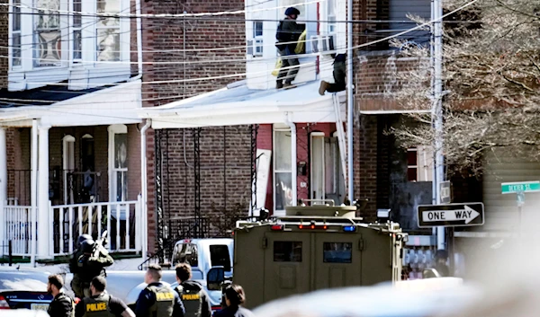 Police surround the suspect's home in Trenton, N.J., Saturday, March 16, 2024. (AP)