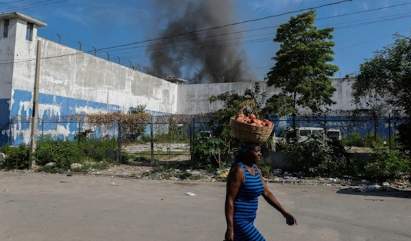 National Police stand guard outside the empty National Penitentiary after a small fire inside in downtown Port-au-Prince, Haiti, Haiti, Thursday, March 14, 2024. (AP)