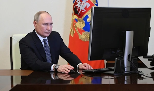 Russian President Vladimir Putin attends an electronic voting during a presidential voting at the Novo-Ogaryovo state residence outside Moscow, Russia, Friday, March 15, 2024. (AP)