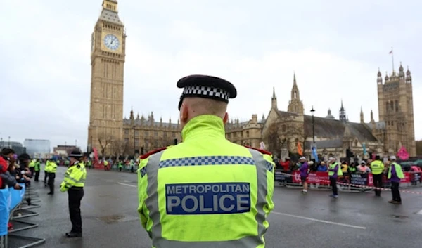 A met police officer stands in front of the Big Ben, in London, UK (AFP)