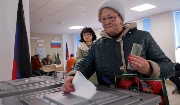 A woman casts her ballot at a polling station during a presidential election in Mariupol in Russian-controlled Donetsk region of eastern Ukraine, Sunday, March 17, 2024. (AP)