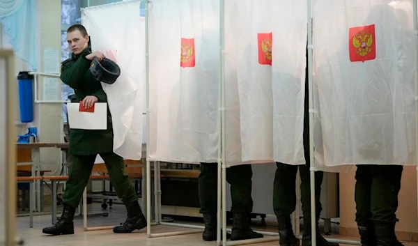 A Russian serviceman leaves a voting booth at a polling station during a presidential election in St. Petersburg, Russia, Friday, March 15, 2024 (AP)