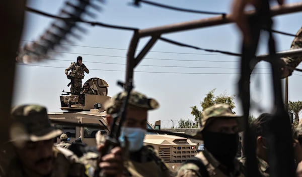 U.S.-backed Syrian Democratic Forces (SDF) militants sit on their armored vehicles, at al-Sabha town in the eastern countryside of Deir Ezzor Syria, Monday, Sept. 4, 2023.(AP)