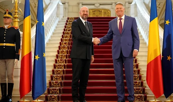 European Council President Charles Michel shakes hands with Romanian President Klaus Iohannis at the Cotroceni Presidential Palace in Bucharest, Romania, March 27, 2023 (AP).