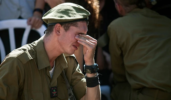 An Israeli soldier mourns over the grave of reserve Master Sgt. Yair Ashkenazy, 36, during his funeral at the military cemetery in Rehovot,' Israel', Friday, July 25, 2014. (AP)