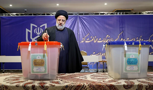 In this photo released by the official website of the Iranian presidency office, President Ebrahim Raisi casts his ballot during the parliamentary and Assembly of Experts elections in Tehran, Iran, Friday, March 1, 2024 (AP)