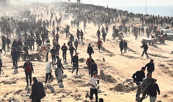 Palestinians wait for humanitarian aid on a beachfront in Gaza City, Gaza Strip, Sunday, Feb. 25, 2024. (AP)