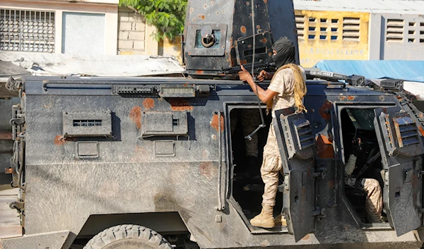 Police take cover during an anti-gang operation in Port-au-Prince, Haiti, Friday, March 1, 2024 (AP)