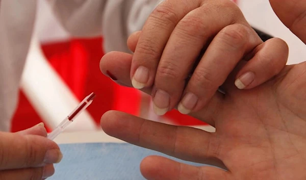 A man undergoes a screening for HIV in Monaco on November 25, 2015. ( AFP)