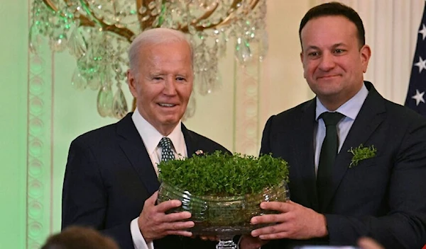 Irish Taoiseach Leo Varadkar (R) gifts a bouquet of Shamrocks to US President Joe Biden during a St. Patrick's Day Celebration at the White House in Washington, on March 17, 2024. (AFP)