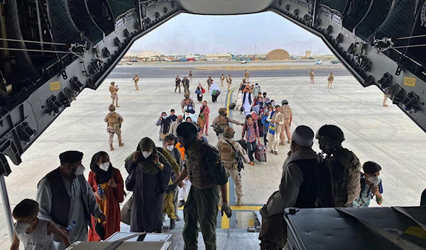 people board a Spanish airforce A400 plane as part of an evacuation plan at Kabul airport in Afghanistan, Wednesday Aug. 18, 2021. (AP)